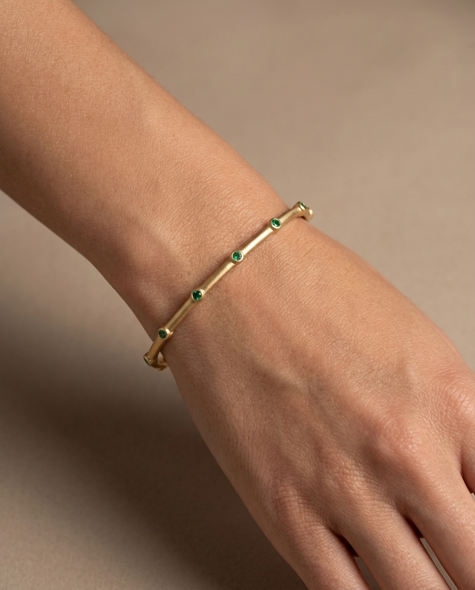 14KT Gold Emerald Bangle with Matte Finish on model