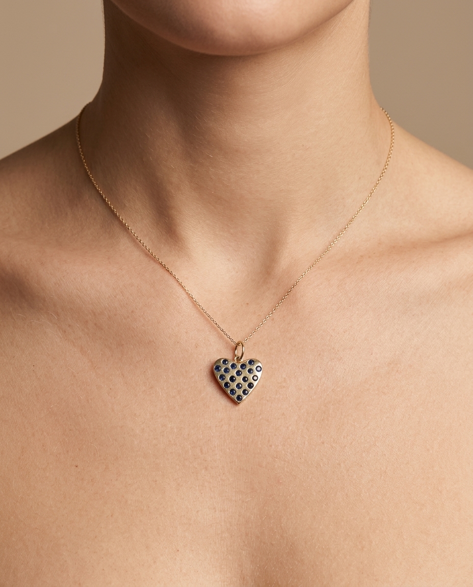 14KT Gold Heart Pendant with Blue Sapphire on model