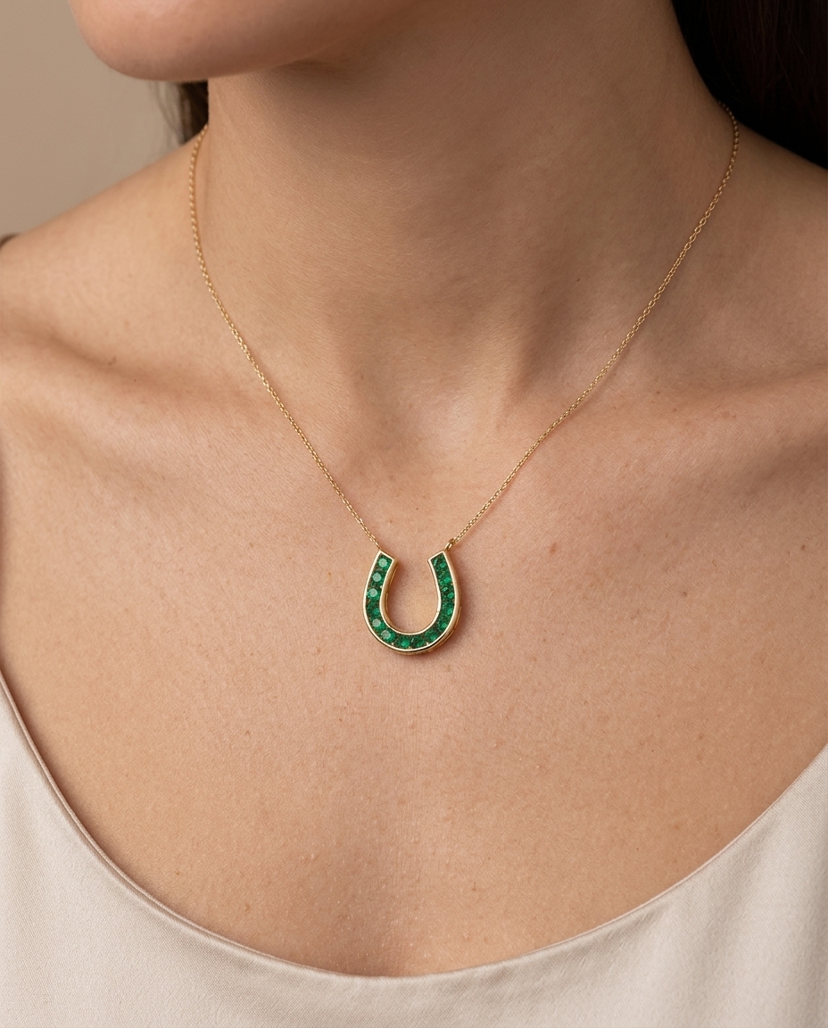14KT Gold Emerald Horseshoe Pendent on model