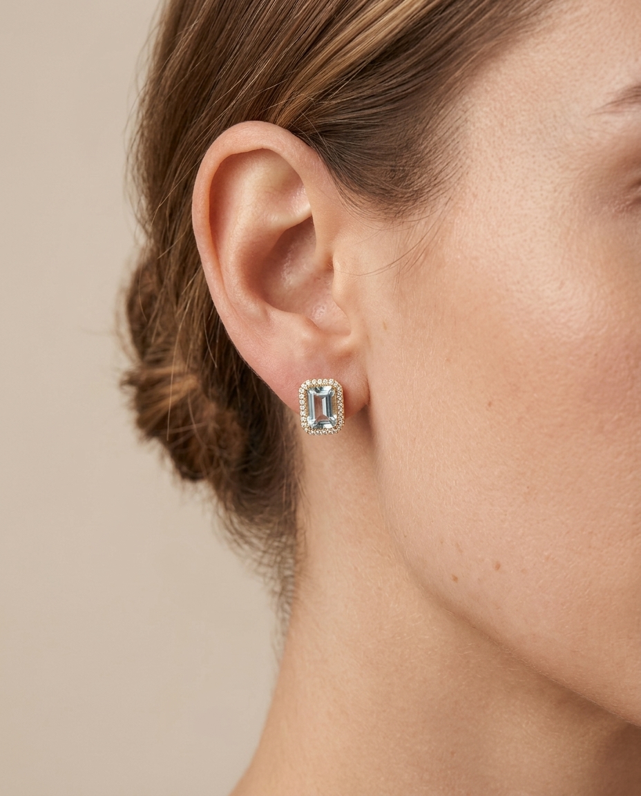 14KT Gold Emerald Cut Blue Topaz and Diamond Stud Earring on model