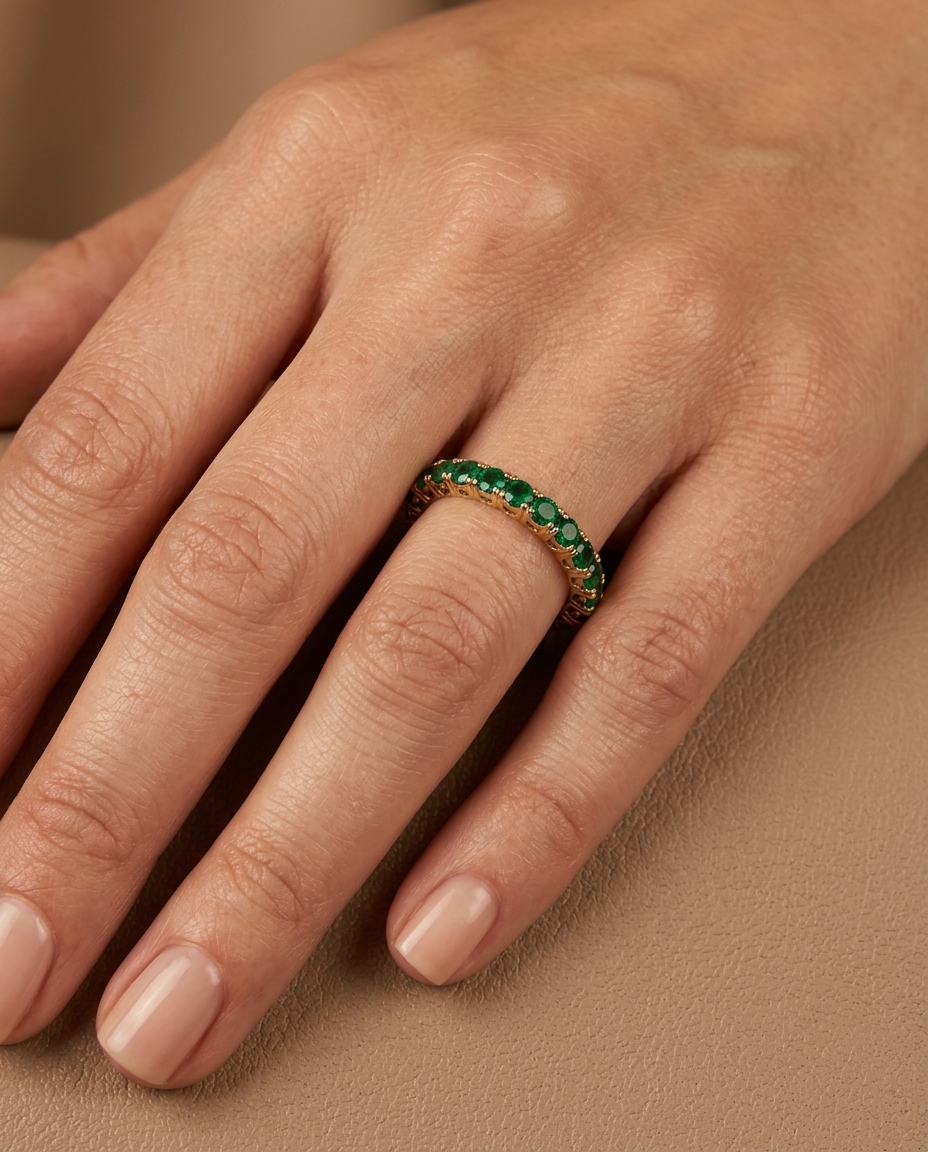 Half Diamond and Half Emerald Eternity Band in Yellow Gold on model